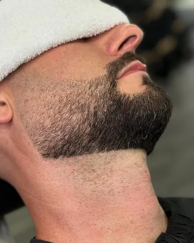 Hot towel treatment during a straight-razor shave at Victory Barbershop