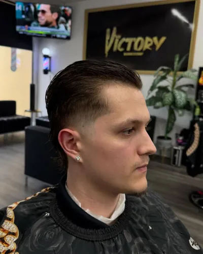 Slicked-back taper with length left at the neck, side profile